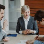 Business people signing a contract at a table
